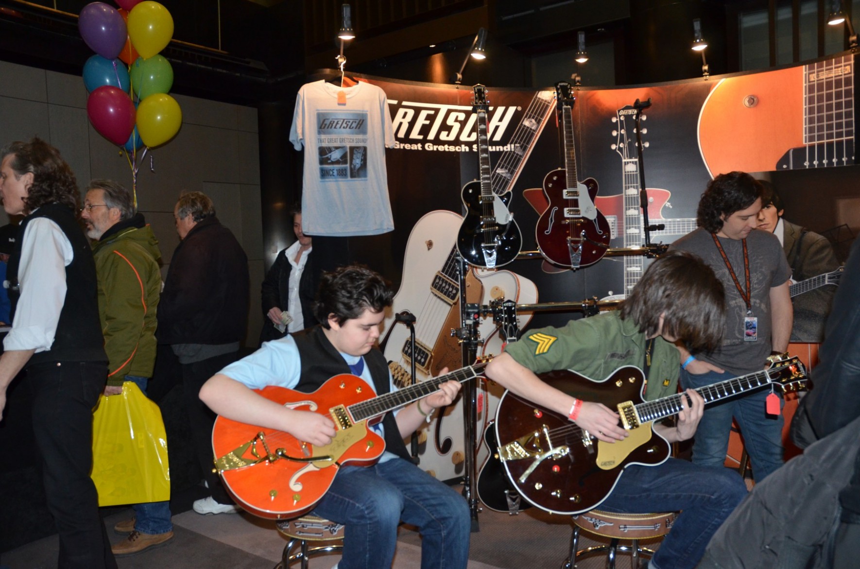 Fest attendees enjoy the Gretsch George Harrison exhibit outside The Cavern ballroom.